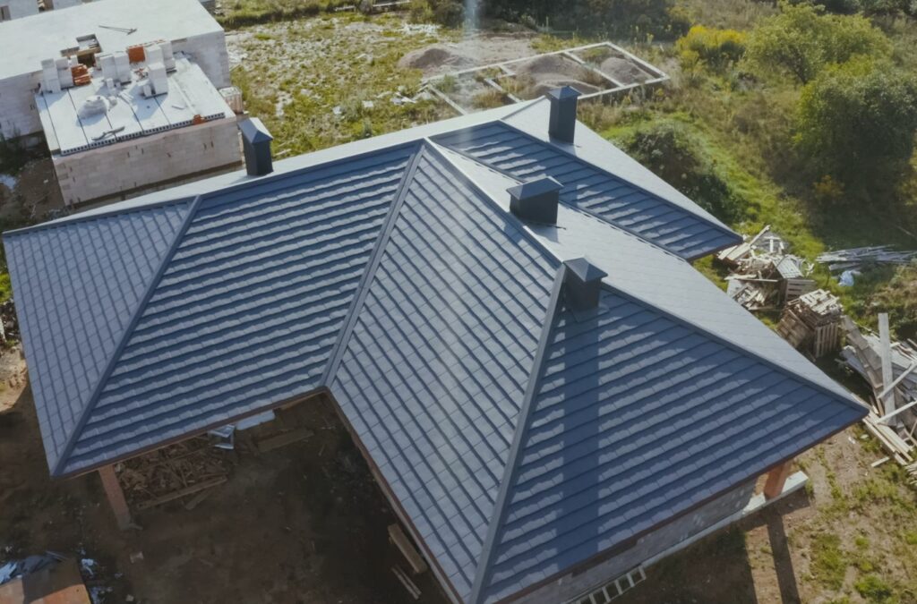 A Emerald Roofing and Siding crew member applying metal panels in Nanuet, NY, illustrating roofing efficiency and sustainability.