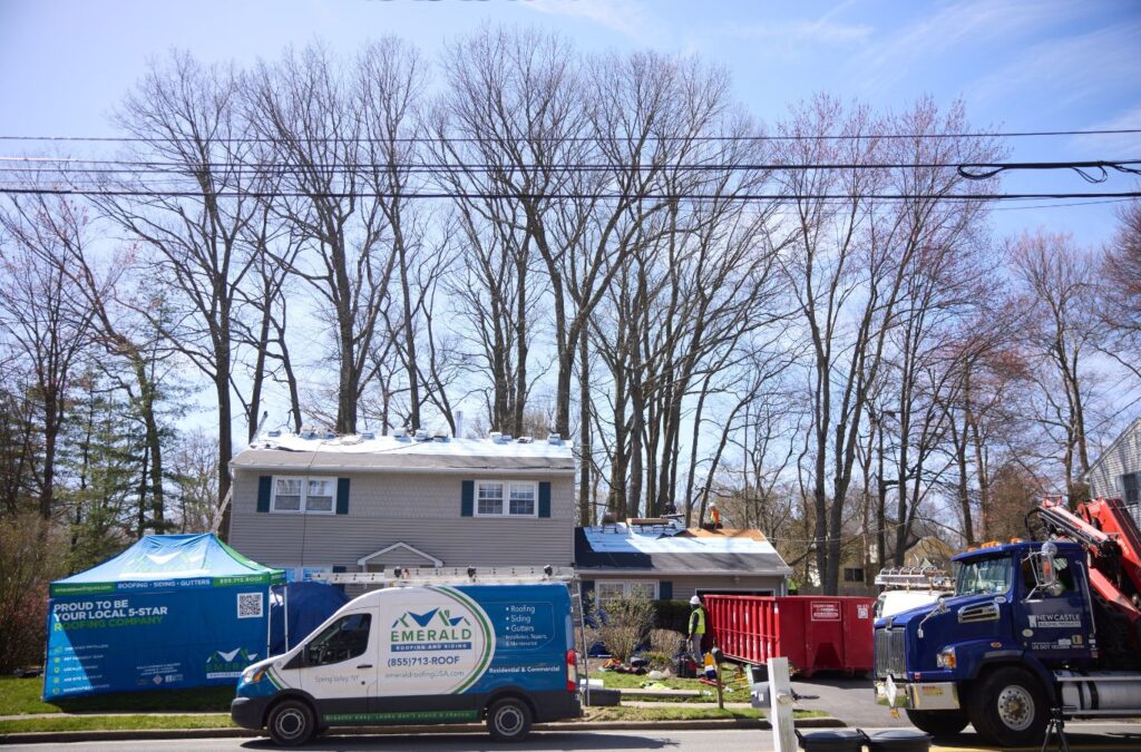 A Emerald Roofing and Siding professional inspecting a finished metal roof in Nanuet, NY, emphasizing service excellence and care. Metal Roofer near me.