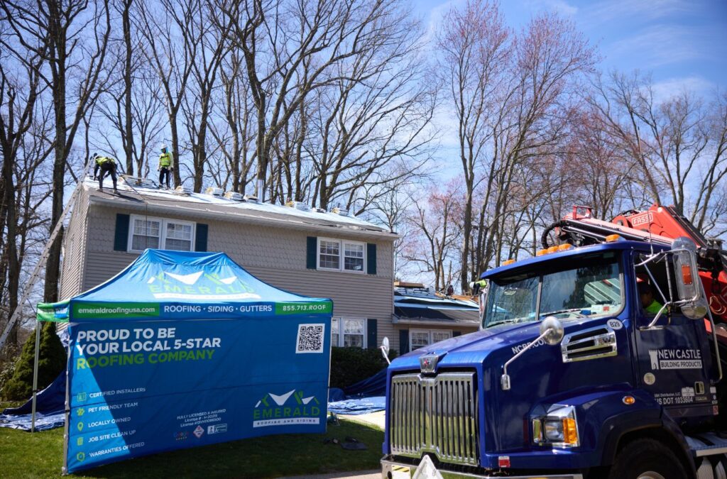 A Emerald Roofing and Siding crew member finalizing a metal roofing system in New City, NY, demonstrating top-tier installation practices. Metal Roofer near me.