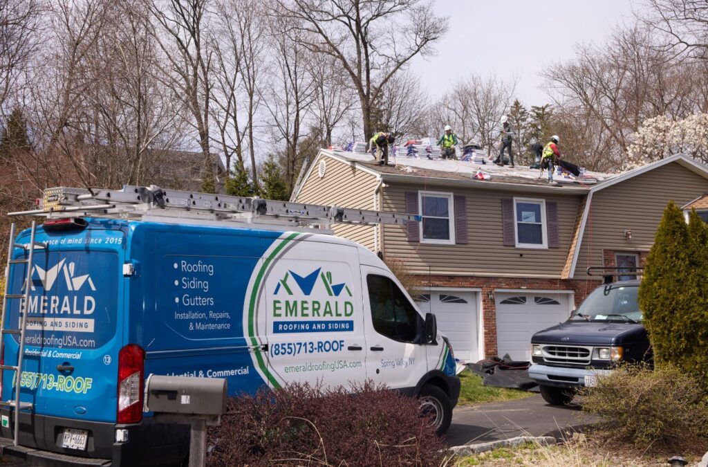 A Emerald Roofing and Siding technician finalizing a metal roof installation in Pearl River, NY, reflecting commitment and expert service. Metal Roofer near me.