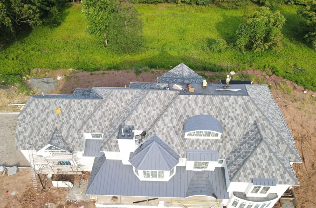 A dedicated Emerald Roofing and Siding worker demonstrating metal roofing application in West Nyack, NY, emphasizing reliable, long-lasting roofing advantages.