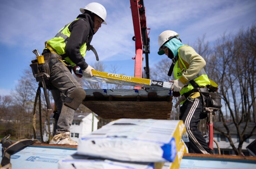 Emerald Roofing and Siding team member completing roofing work in Suffern, NY, highlighting the value of hiring skilled local roof professionals.