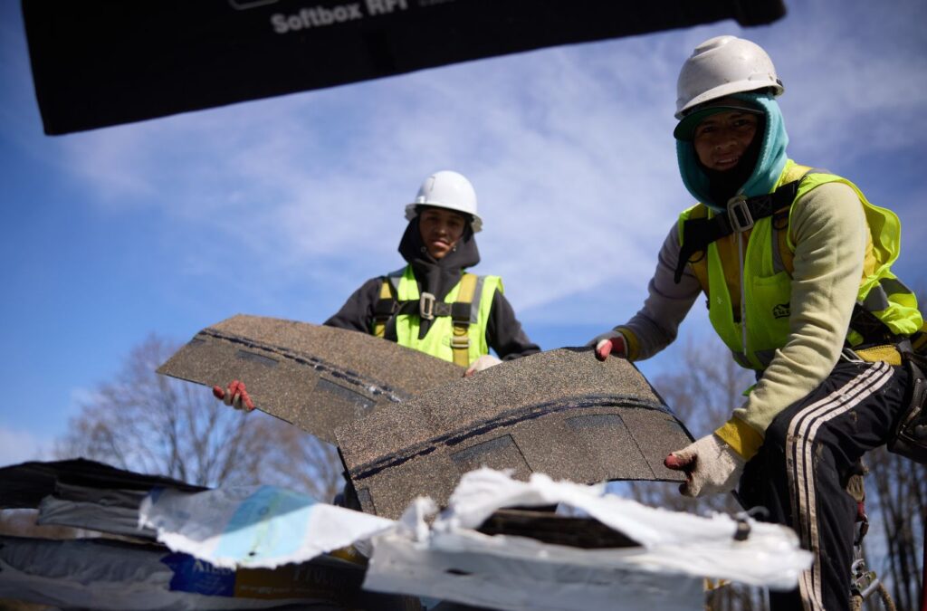 Emerald Roofing and Siding roofer installing quality shingles in Suffern, NY using professional tools, showing the advantages of hiring a reliable local shingle roofer.