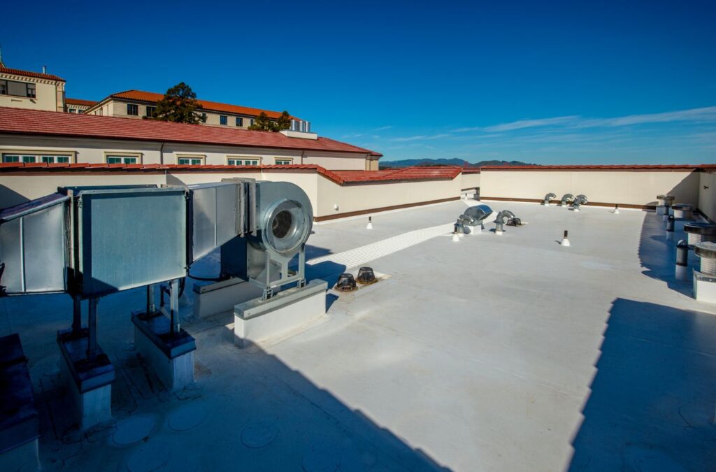 Emerald Roofing and Siding technician performing flat roof repair in Suffern, NY using industry-grade tools to fix leaks and strengthen roofing systems with reliable local expertise.